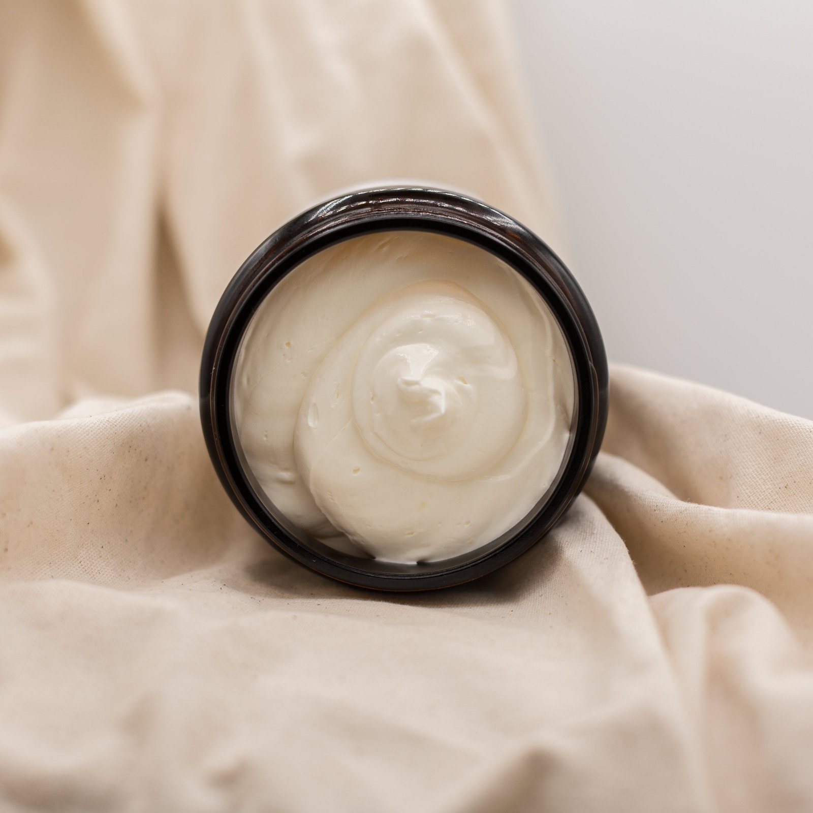 Open jar of Melt by HydroTallow whipped tallow with a soft swirl